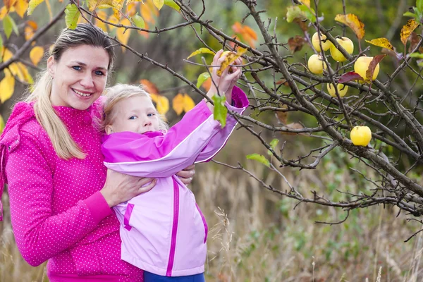 Mãe e sua filha com macieira outonal — Fotografia de Stock