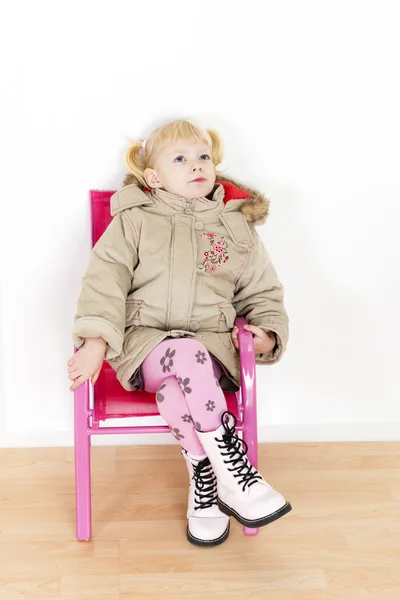 Little girl sitting on chair — Stock Photo, Image