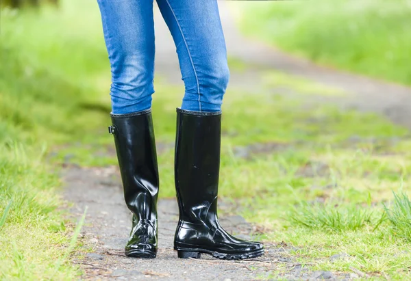 Detail of standing woman wearing rubber boots — Stock Photo, Image