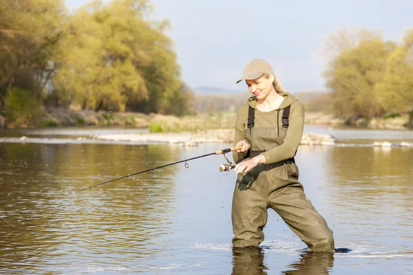 Mulher pesca no rio na primavera — Fotografia de Stock