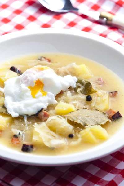 Sauerkraut soup with veiled egg — Stock Image Sauerkraut soup with veiled egg Royalty Free Stock Photos