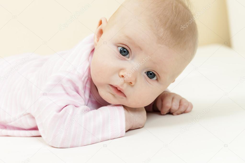 portrait of lying three months old baby girl