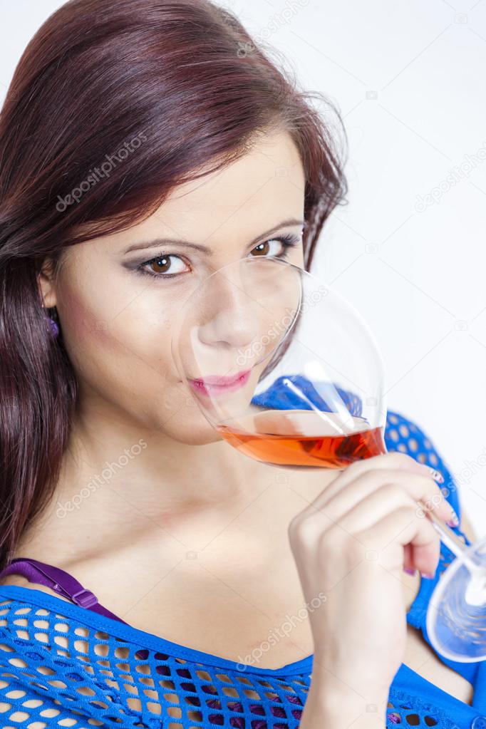 Young woman drinking rose wine