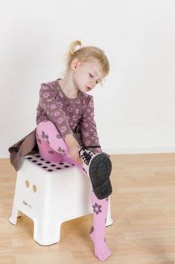 küçük kız botlar koymak