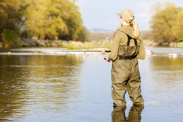 Woman fishing in the river in spring — Stock Photo, Image