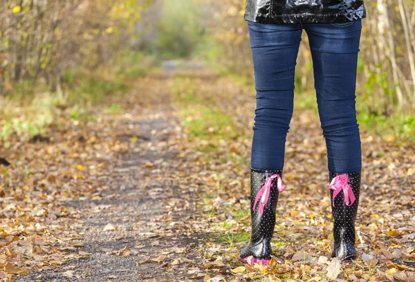 Woman wearing black rubber boots — Zdjęcie stockowe