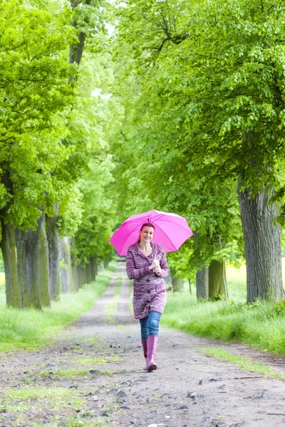 Mulher usando botas de borracha com guarda-chuva — Fotografia de Stock