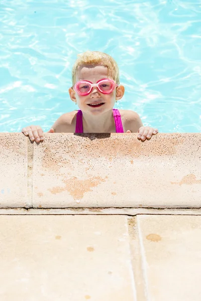 Маленькая девочка плавает в бассейне — стоковое фото