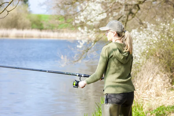 Woman fishing at pond in spring — Stock Photo, Image