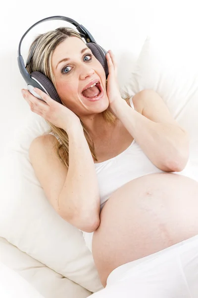 Mulher grávida com fones de ouvido — Fotografia de Stock