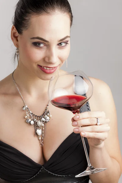 Portrait of young woman with a glass of red wine — Stock Photo, Image