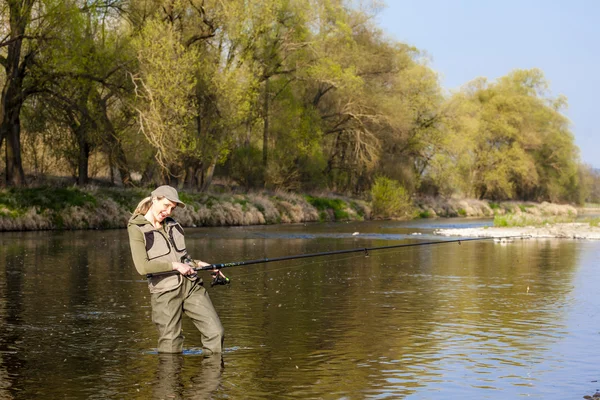 Woman fishing in the river in spring — Stock Photo, Image