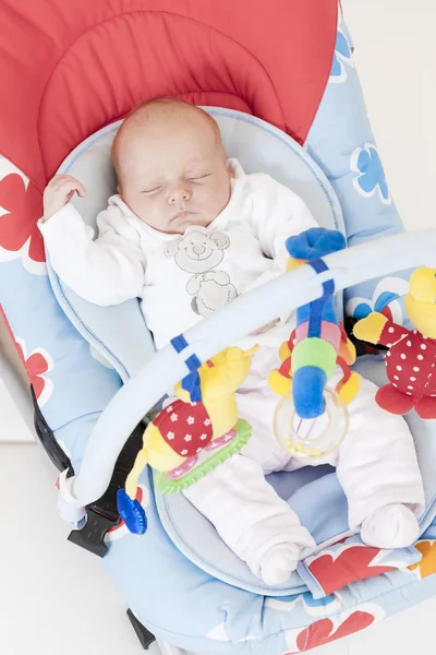 One month old baby girl sleeping in baby''s chair — Stock Photo, Image