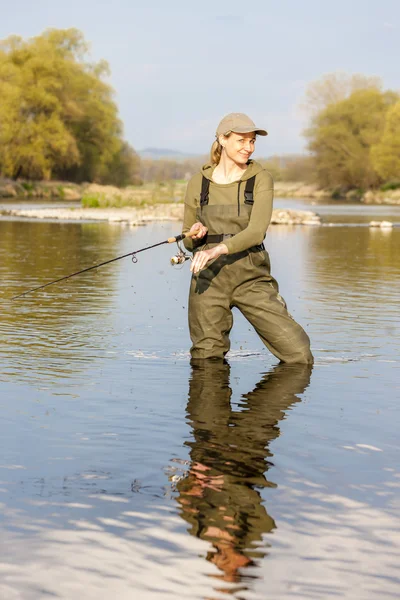 Woman fishing in the river in spring — Stock Photo, Image