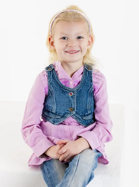 Portrait of sitting little girl wearing jeans — Stock Photo, Image