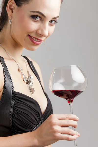 Portrait of young woman with a glass of red wine — Stock Photo, Image