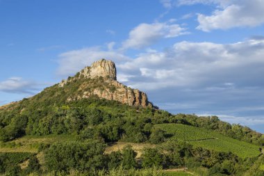 Roche de Solutre, a prominent limestone escarpment, rising above Solutre Pouilly vineyards in Saone et Loire, France