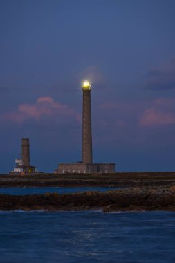 Gatteville le Phare 'in kayalık sahillerinde duran iki deniz feneri ve bina.