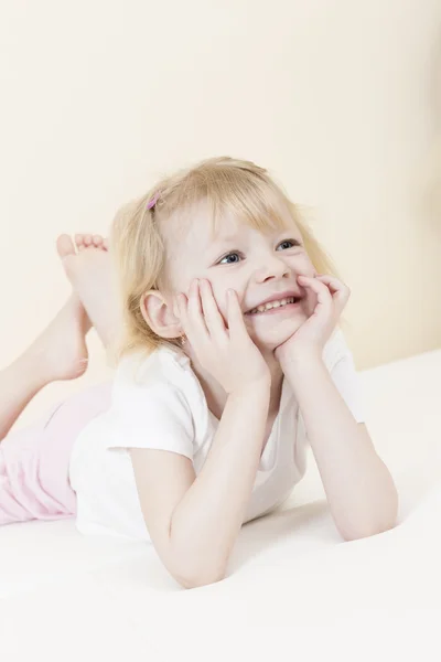 Portrait of lying little girl — Stock Photo, Image