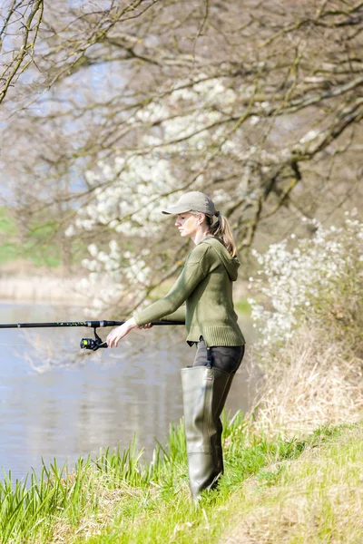 Woman fishing at pond in spring — Stock Photo, Image