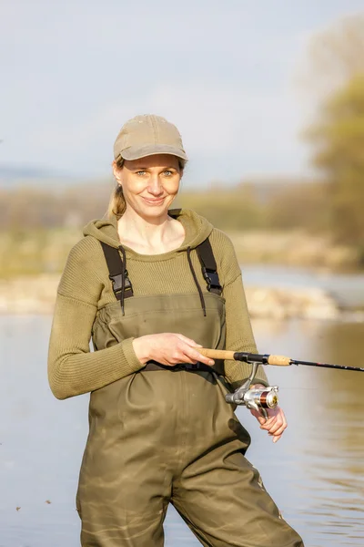 Woman fishing in the river — Stock Photo, Image