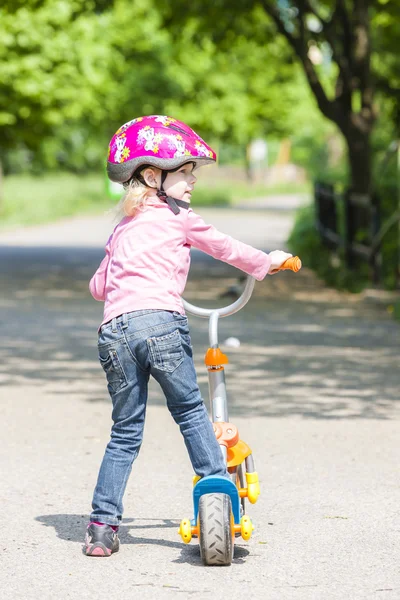 Little girl with a scooter — Stock Photo, Image