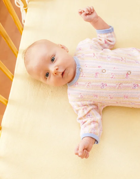 Portrait of lying a two month old baby girl in cot — Stock Photo, Image