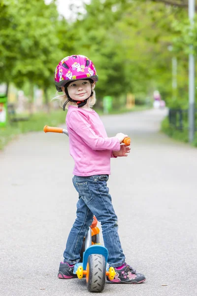 Little girl with a scooter — Stock Photo, Image