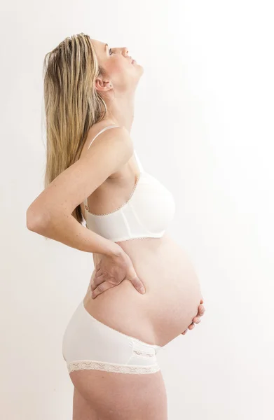 Standing pregnant woman wearing lingerie — Stock Photo, Image
