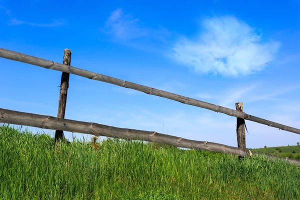 Wooden fence on meadow — Stock Photo, Image