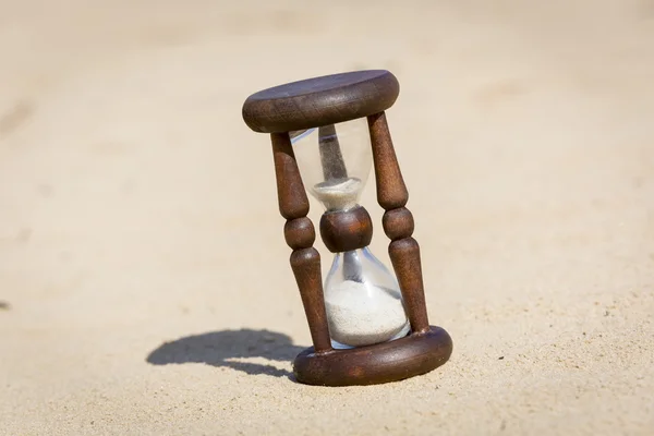 Hourglass in desert on sand — Stock Photo, Image