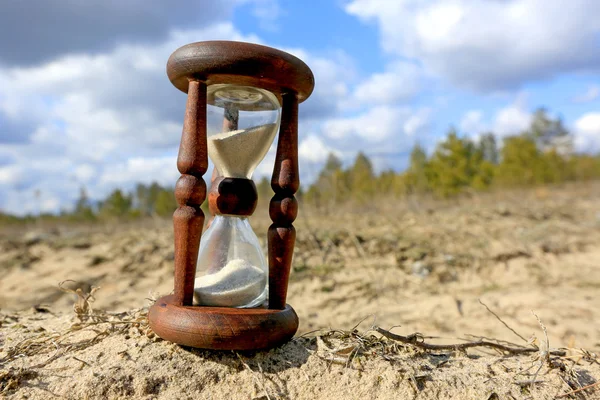 Hourglass on sand — Stock Photo, Image