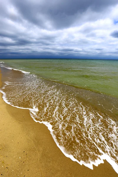 Sandy sea shore on storm — Stock Photo, Image