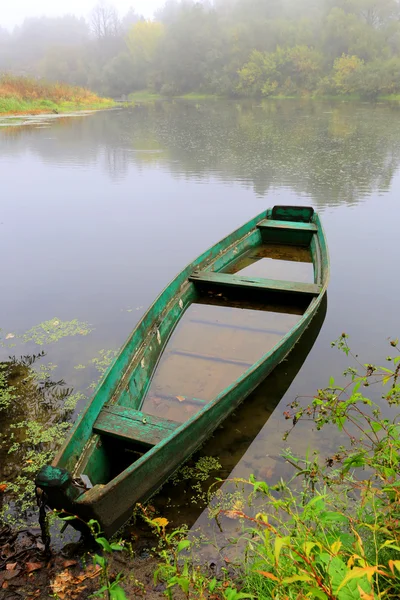 Wooden boat on river — Stock Photo, Image
