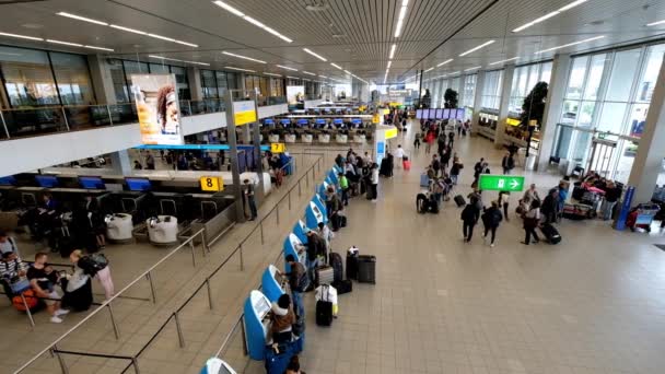 La gente visita la sala de salidas en el aeropuerto internacional de Schiphol — Vídeo de stock
