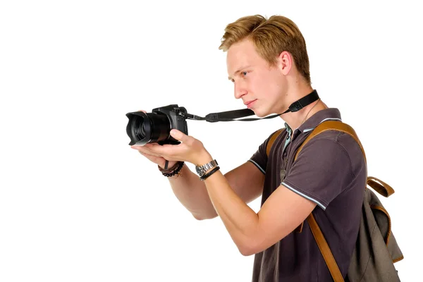Young man traveler taking pictures by dslr camera isolated — Stock Photo, Image