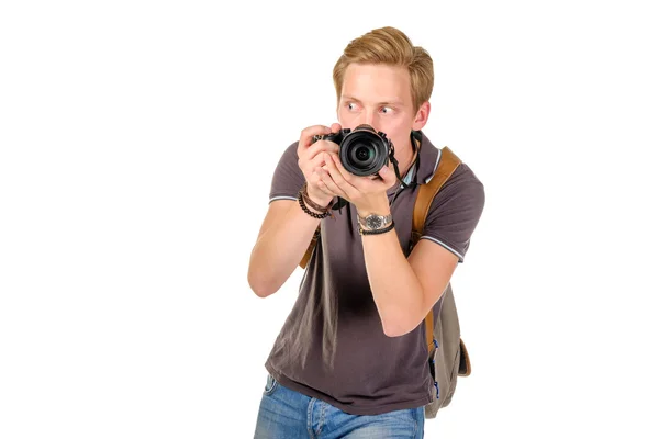 Young man traveler taking pictures by dslr camera isolated — Stock Photo, Image