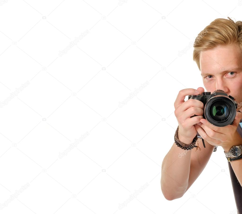 Young man traveler taking pictures by dslr camera isolated