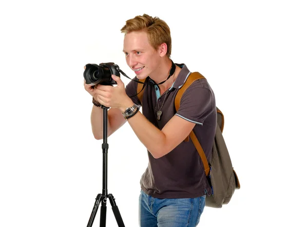 Young man traveler taking pictures by dslr camera isolated — Stock Photo, Image