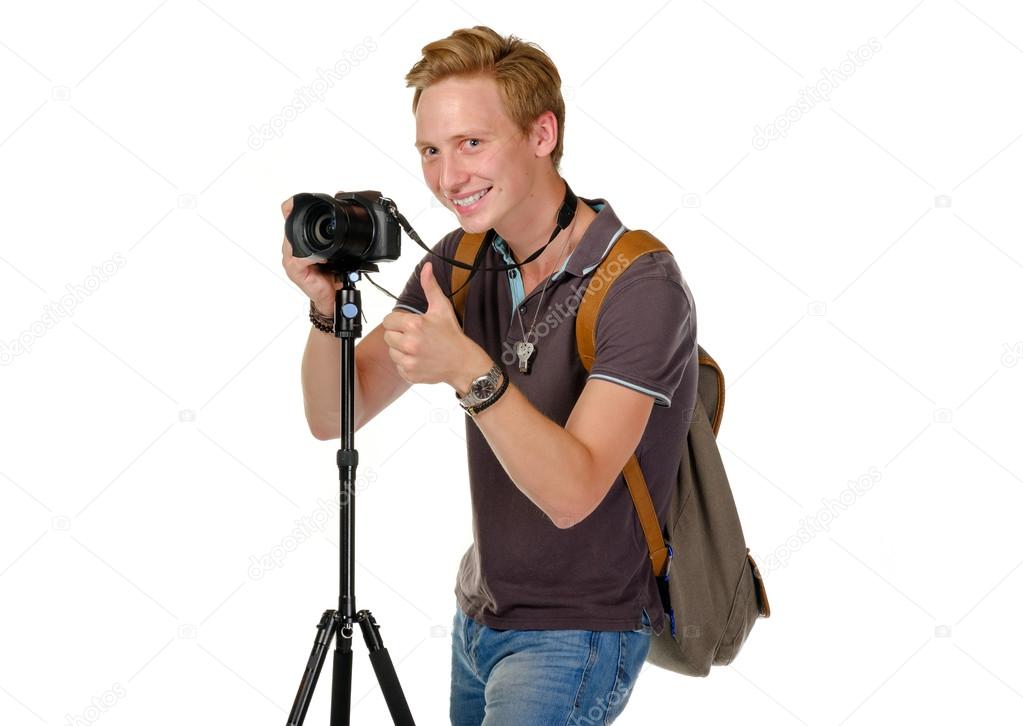 Young man traveler taking pictures by dslr camera isolated