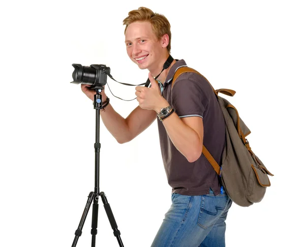 Young man traveler taking pictures by dslr camera isolated — Stock Photo, Image