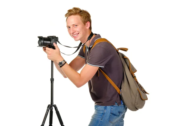 Young man traveler taking pictures by dslr camera isolated — Stock Photo, Image