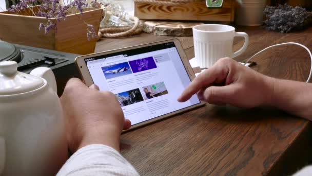 El hombre visita el sitio web fedex en la tableta PC en un café — Vídeos de Stock