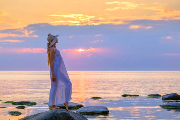 Graceful woman on seashore at sunset — Stock Photo, Image