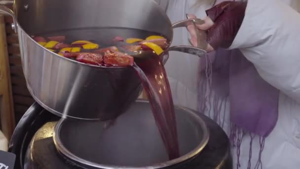 Crop woman pouring mulled wine into pot — Stock Video