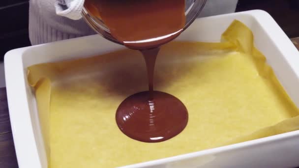 Crop housewife pouring chocolate in baking form with parchment — Stock Video