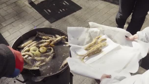 Crop vendors putting fried fish on tray — Stock Video