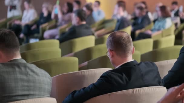 El público escucha al conferenciante en la sala de conferencias — Vídeo de stock