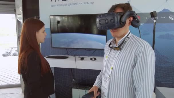 Man experiencing VR device during exhibition — Stock Video