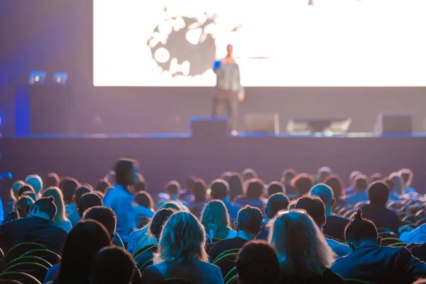 Audience sitting near illuminated stage — Stock Photo, Image